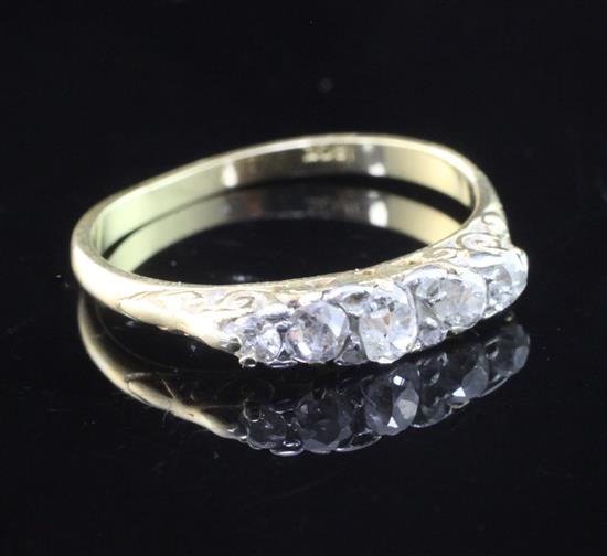 A 18ct gold and graduated five stone diamond ring, size M.